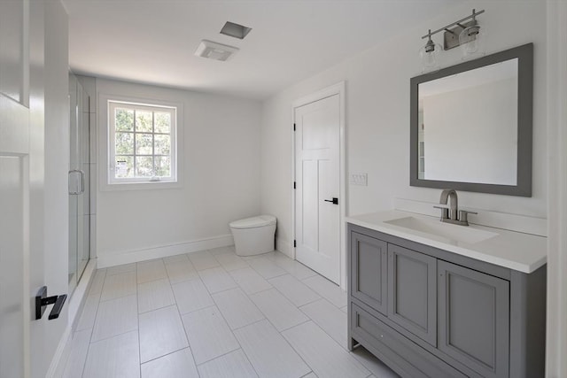 full bath with a shower stall, toilet, vanity, and baseboards