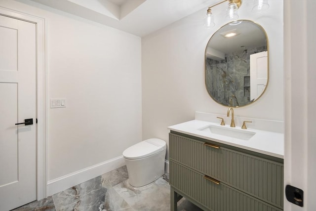 bathroom with a shower, toilet, vanity, and baseboards