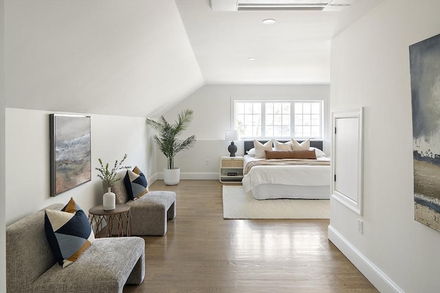 bedroom featuring vaulted ceiling, wood finished floors, and baseboards