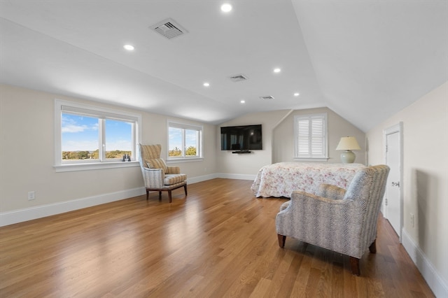 bedroom featuring vaulted ceiling and light wood-type flooring