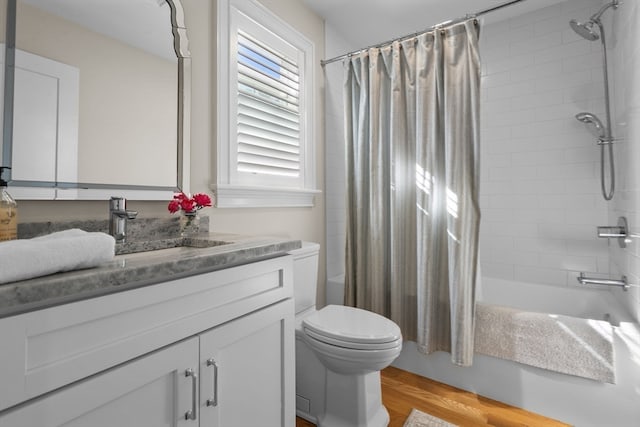 full bathroom featuring shower / bath combination with curtain, toilet, wood-type flooring, and vanity