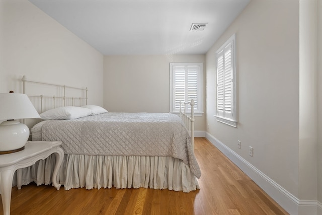 bedroom with hardwood / wood-style flooring