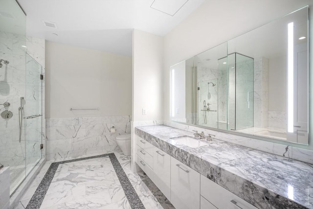 bathroom featuring vanity, toilet, and an enclosed shower