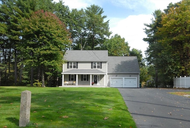 9 Pine Grove Rd, Westford, MA 01886 - colonial inspired home featuring a front lawn, fence, covered porch, an attached garage, and driveway