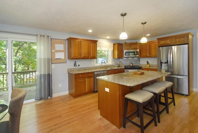 9 Pine Grove Rd, Westford, MA 01886 - kitchen with baseboards, a sink, light wood-style flooring, and appliances with stainless steel finishes