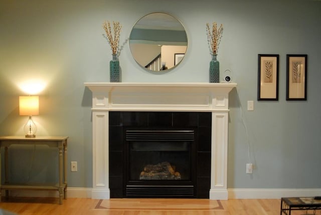 9 Pine Grove Rd, Westford, MA 01886 - room details featuring a tiled fireplace, baseboards, and wood finished floors
