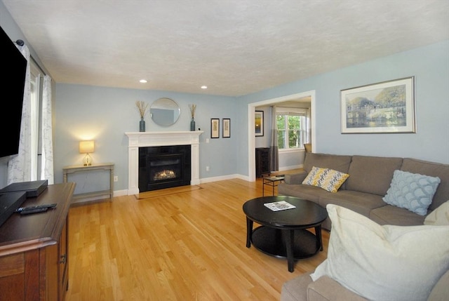 9 Pine Grove Rd, Westford, MA 01886 - living room with light wood-style floors, baseboards, recessed lighting, and a fireplace with flush hearth