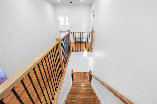 stairs featuring hardwood / wood-style flooring