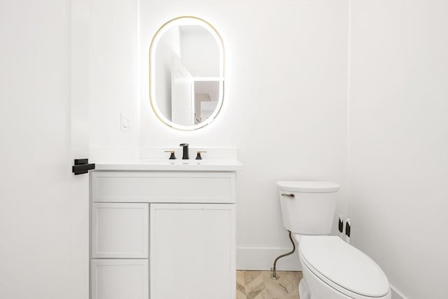 bathroom featuring toilet and vanity