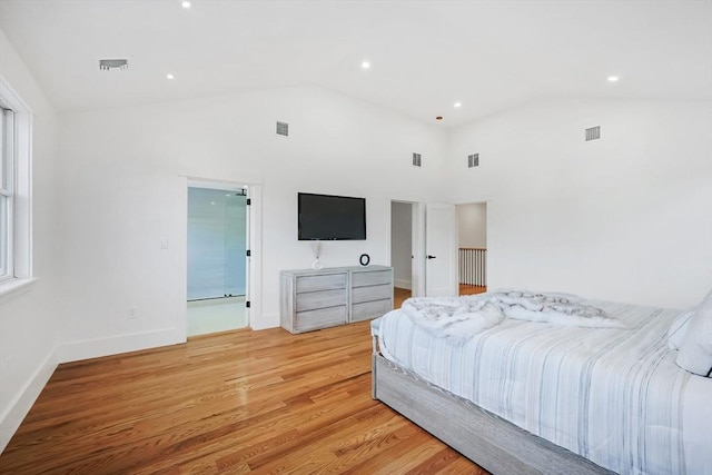 bedroom with light hardwood / wood-style floors and high vaulted ceiling