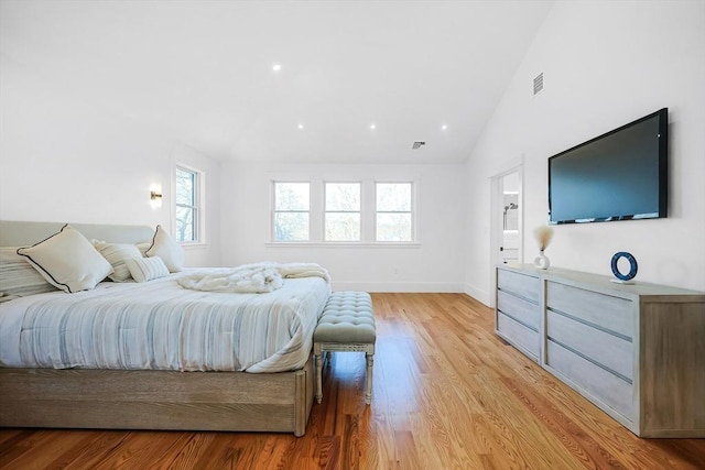 bedroom featuring vaulted ceiling and light hardwood / wood-style flooring