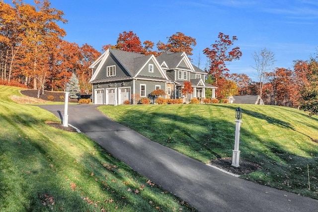 view of front of property with a front lawn and a garage