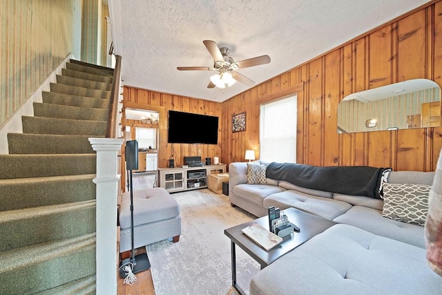 78/80 Curtis Ave, Quincy, MA 02169 - living room featuring stairway, a ceiling fan, wooden walls, a textured ceiling, and light wood-type flooring