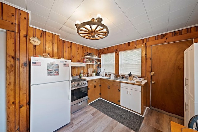 78/80 Curtis Ave, Quincy, MA 02169 - kitchen featuring freestanding refrigerator, stainless steel gas range oven, wooden walls, light wood-style flooring, and light countertops