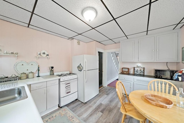 78/80 Curtis Ave, Quincy, MA 02169 - kitchen featuring white appliances, a drop ceiling, light wood-type flooring, white cabinetry, and light countertops