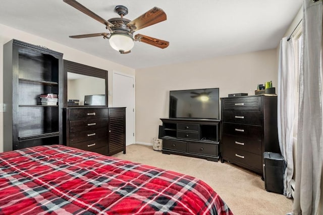 bedroom featuring light carpet and ceiling fan