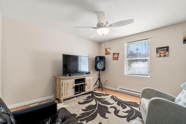 living room featuring a baseboard heating unit, ceiling fan, and light wood-type flooring