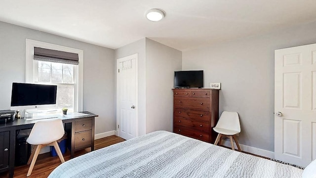 bedroom featuring baseboards and dark wood finished floors