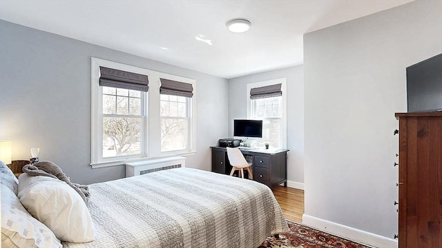 bedroom featuring light wood-style flooring and baseboards