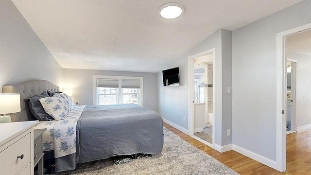 bedroom with baseboards and light wood-style floors