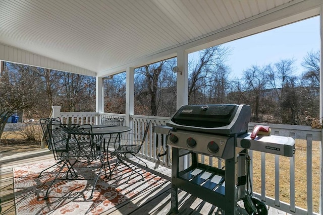 deck featuring outdoor dining space and area for grilling