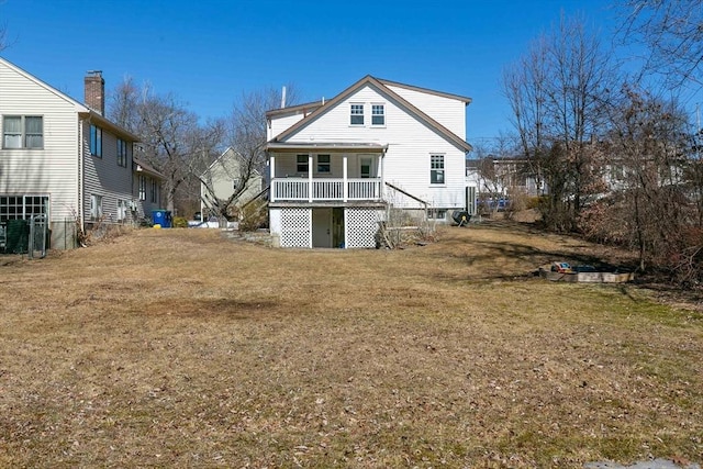 rear view of property with a lawn