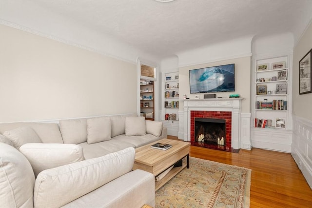 293-295 Commonwealth Ave Unit 3C, Boston, MA 02111 - living area featuring built in features, wood finished floors, and a fireplace