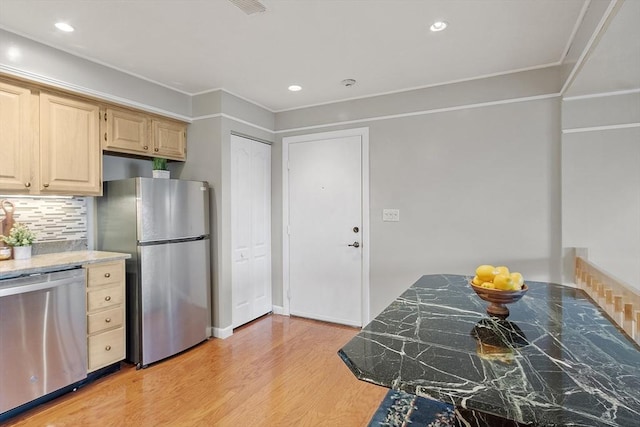 kitchen featuring tasteful backsplash, recessed lighting, light brown cabinetry, stainless steel appliances, and light wood-style floors