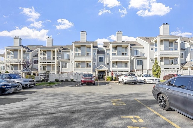view of property featuring a residential view and uncovered parking