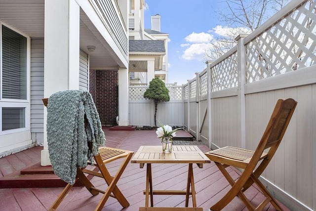 view of patio with a deck and fence
