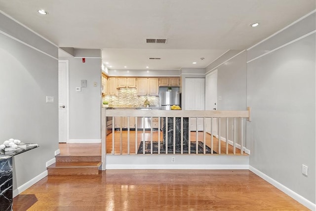 kitchen featuring recessed lighting, decorative backsplash, light wood-style floors, visible vents, and freestanding refrigerator
