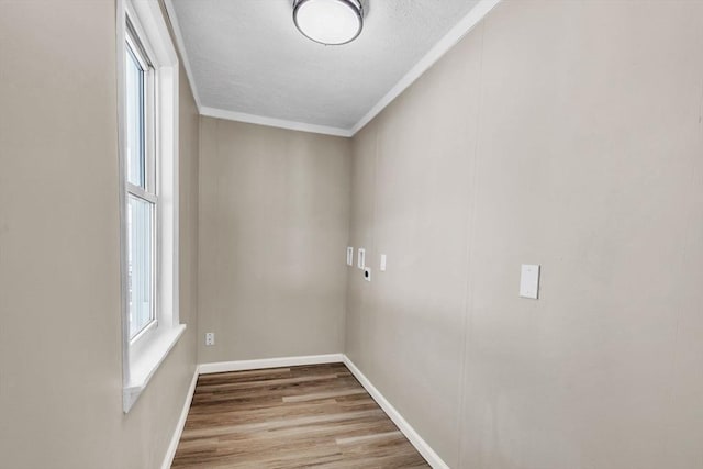 unfurnished room featuring crown molding and light wood-type flooring