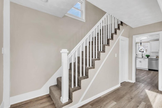 stairs with hardwood / wood-style floors