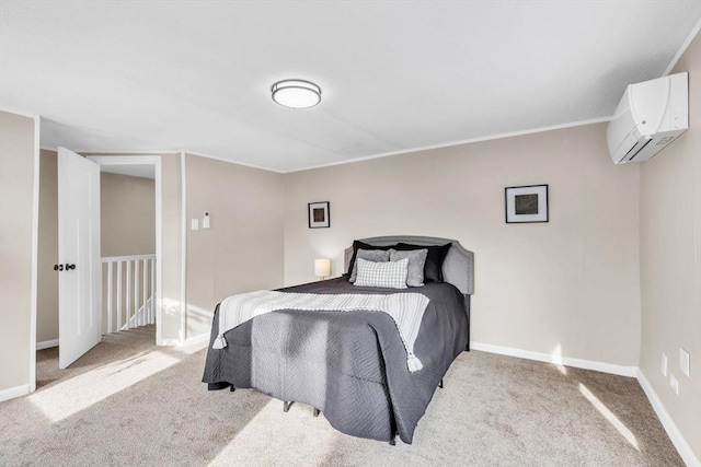 bedroom with a wall mounted air conditioner and light colored carpet