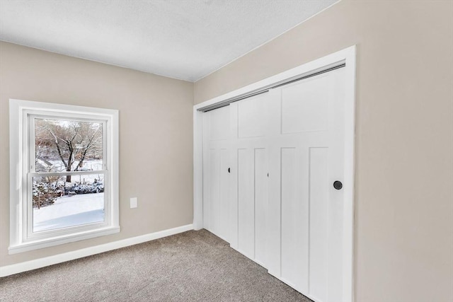 unfurnished bedroom featuring carpet and a closet