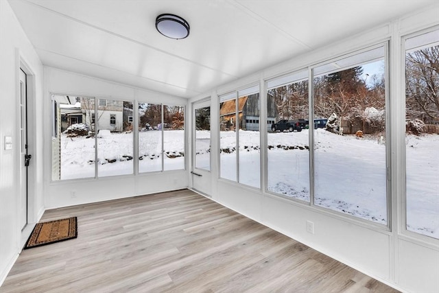 unfurnished sunroom featuring vaulted ceiling