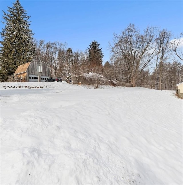 yard covered in snow with an outbuilding