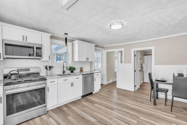 kitchen with white cabinetry, sink, and appliances with stainless steel finishes