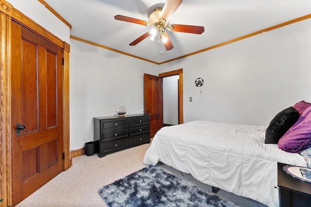 carpeted bedroom featuring baseboards, a ceiling fan, and ornamental molding