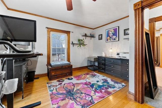 interior space with baseboards, wood finished floors, and crown molding