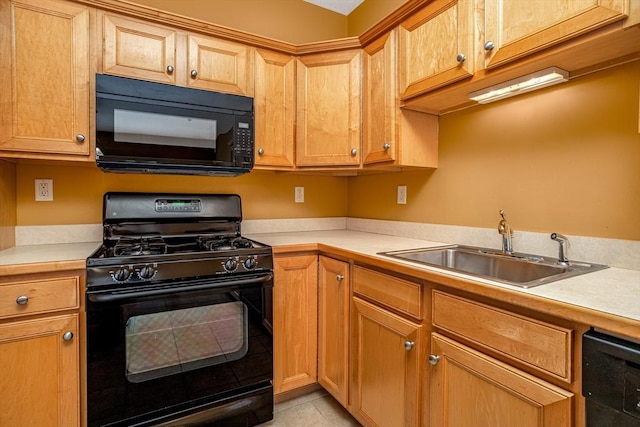 kitchen featuring light countertops, a sink, and black appliances