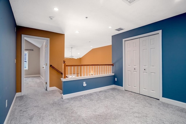 additional living space with visible vents, ceiling fan, lofted ceiling, and carpet floors