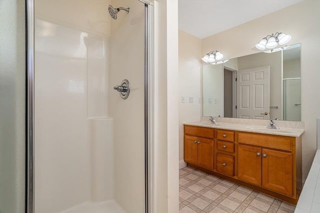 full bathroom with a sink, double vanity, and a stall shower