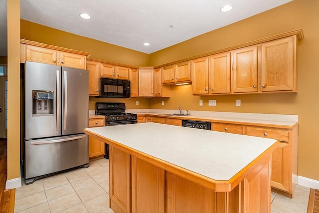 kitchen featuring black appliances, recessed lighting, a center island, a sink, and light countertops