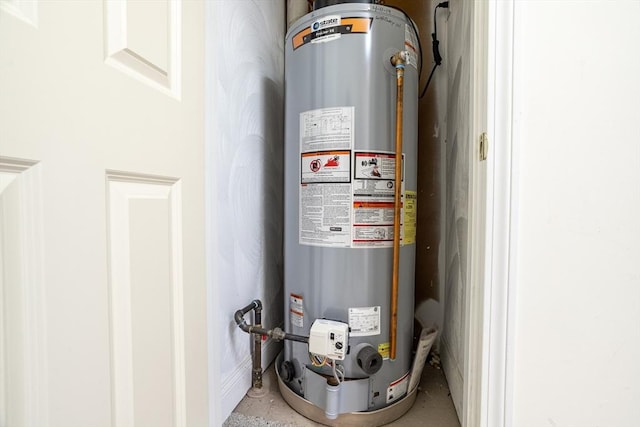 utility room featuring gas water heater