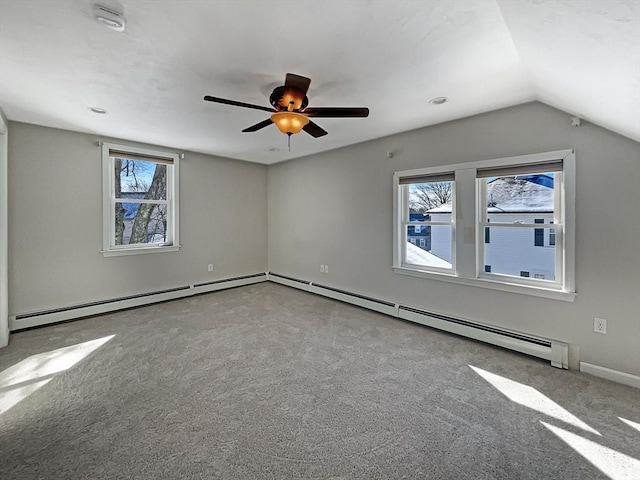 empty room with carpet floors, vaulted ceiling, and a ceiling fan