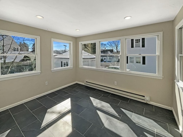 interior space with recessed lighting, baseboards, dark tile patterned floors, and baseboard heating