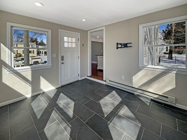 foyer entrance with a healthy amount of sunlight, baseboards, and a baseboard heating unit