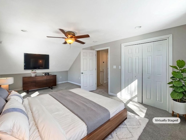 bedroom featuring ceiling fan, a closet, baseboards, and light colored carpet