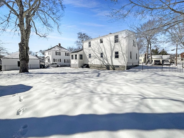 view of snowy exterior with fence